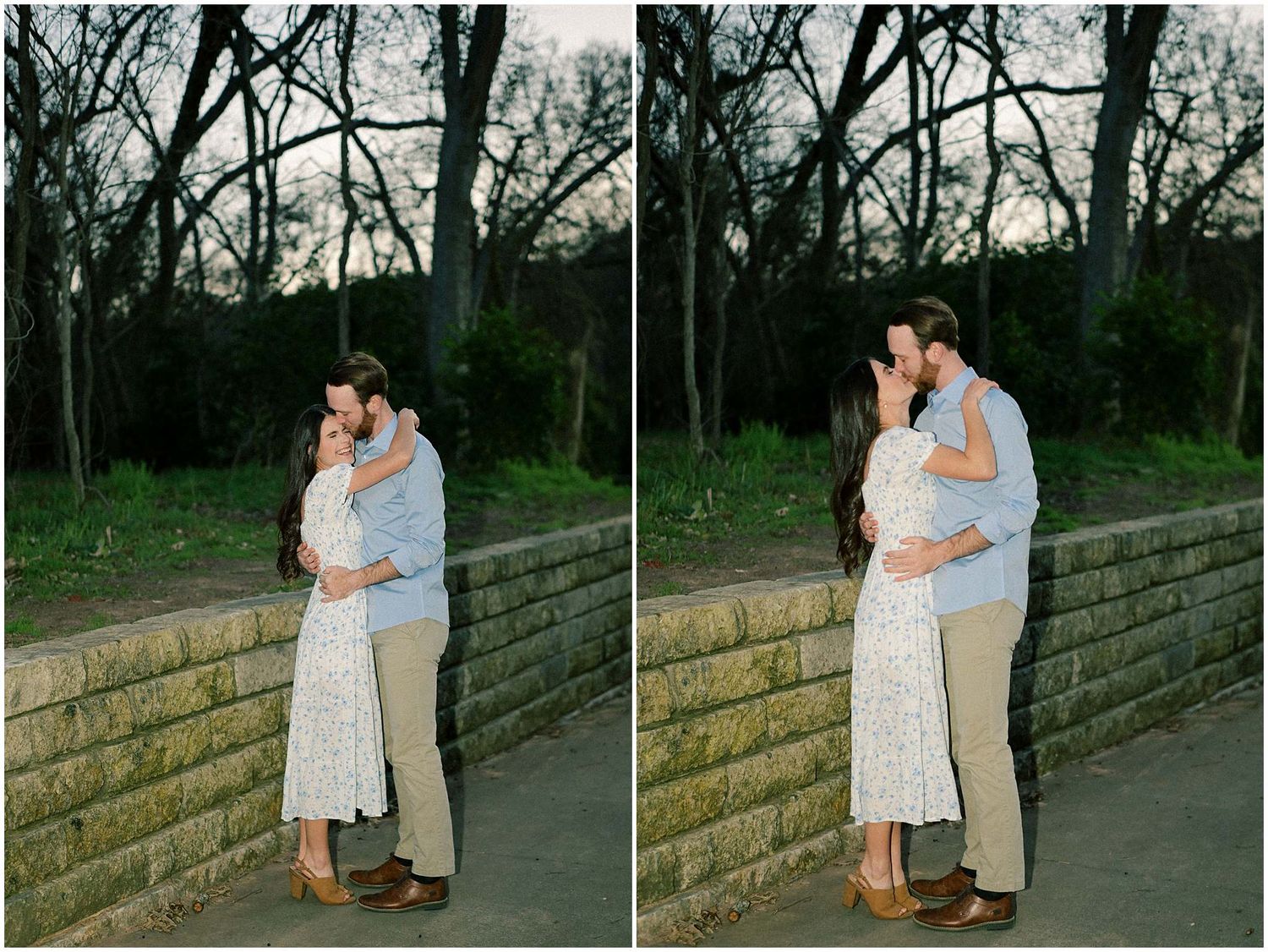 Couple in casual attire embraces along a stone wall pathway at dusk.