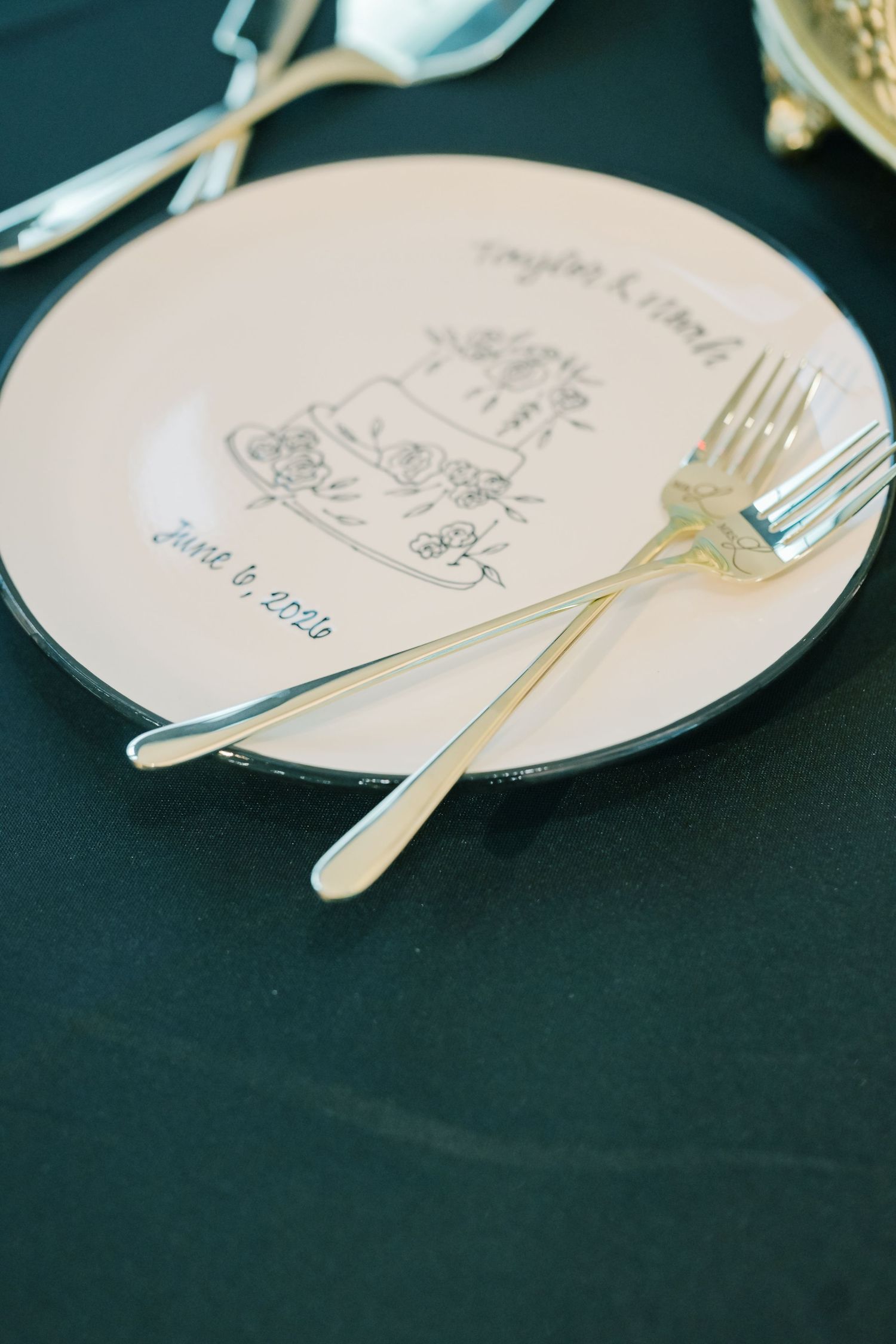 Custom wedding cake plate with couple names and June 2026 date, displayed with silver forks.