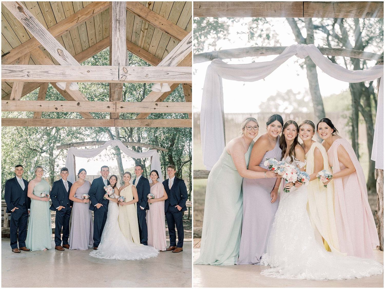 Wedding party members in pastel purple and pink dresses pose together under rustic wooden beams and outdoor scenery.