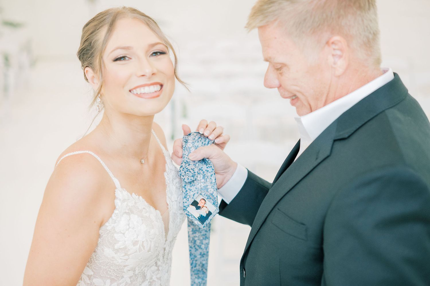 Joyful wedding celebration with elegant attire in light-filled indoor setting.