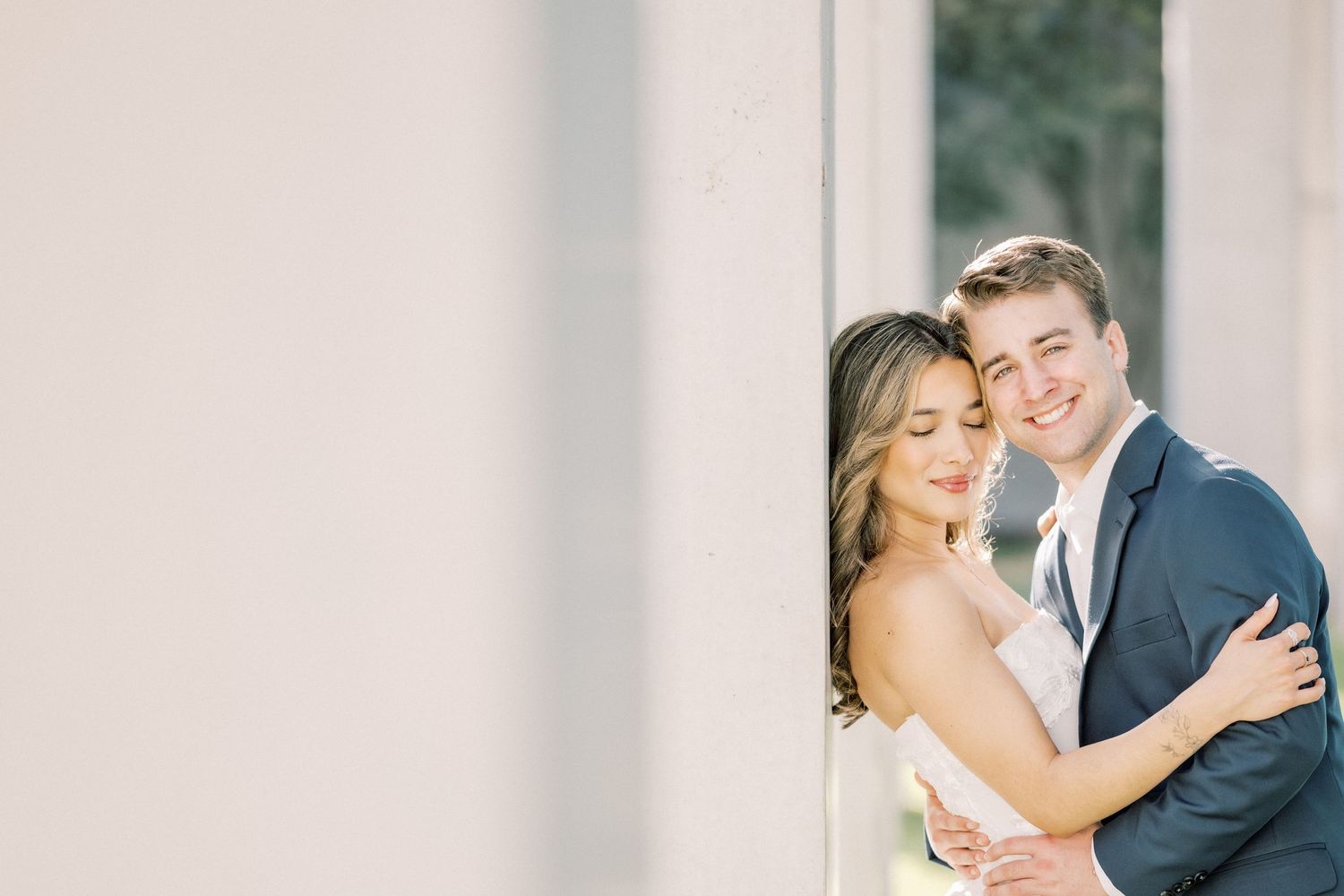 A romantic wedding couple shares intimate moments in a series of elegant outdoor portraits.