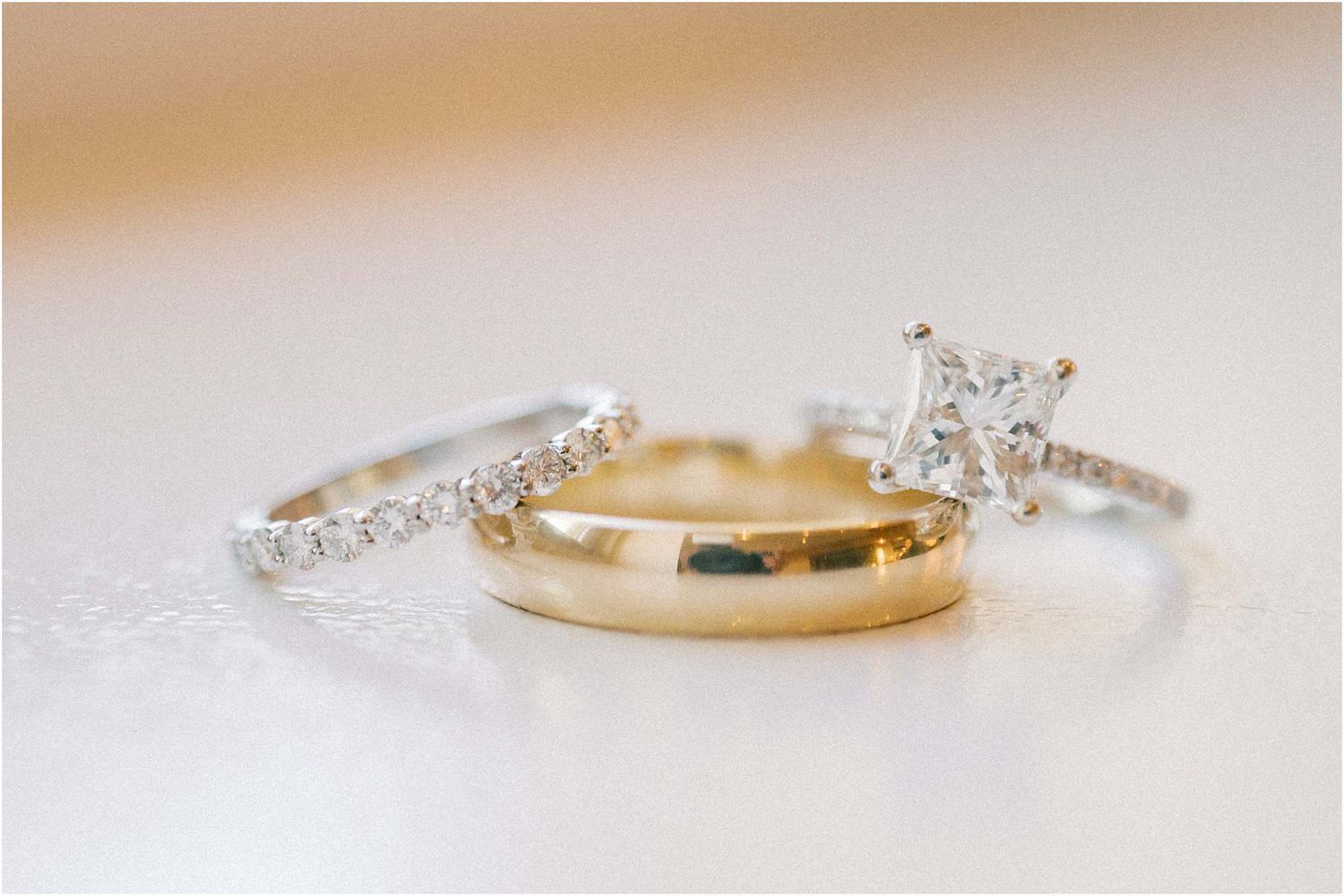 Elegant wedding rings and bands displayed on white surface.