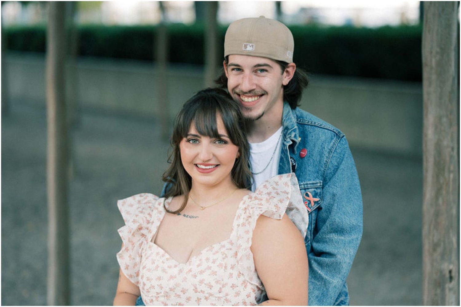 Couple shares joyful moments in casual attire during outdoor photography session.