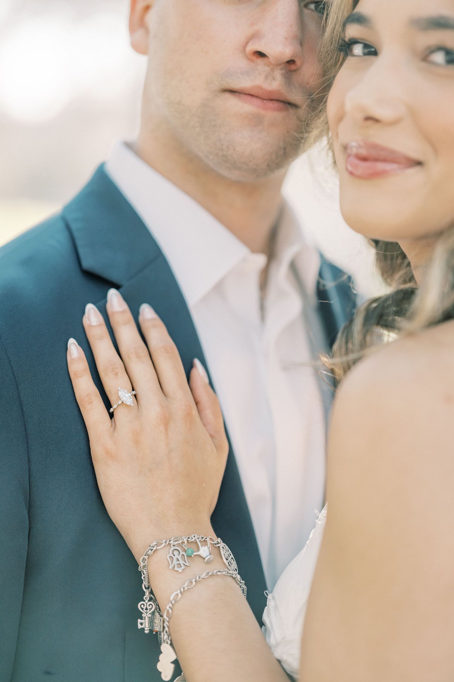 Close-up shots of elegant bridal jewelry featuring a delicate bracelet and engagement ring against soft pastel tones.