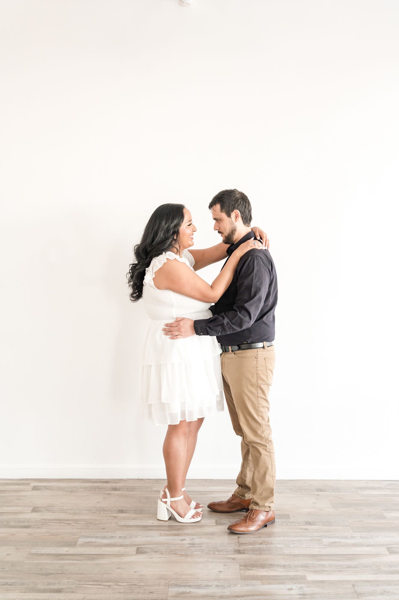 A couple dances and twirls together in a bright studio space, creating playful and romantic moments.