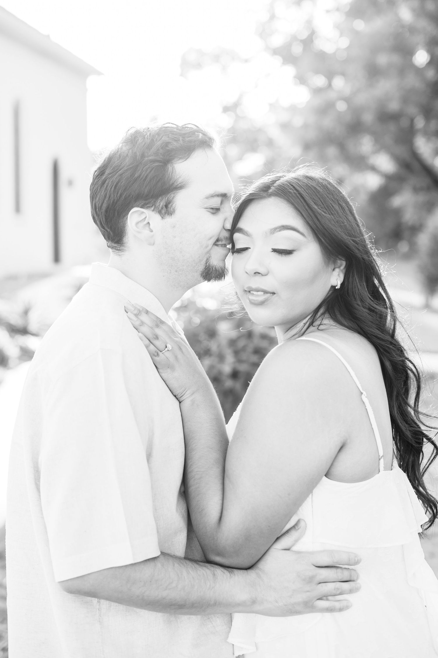 Romantic black and white wedding photo series showing tender moments between a couple.