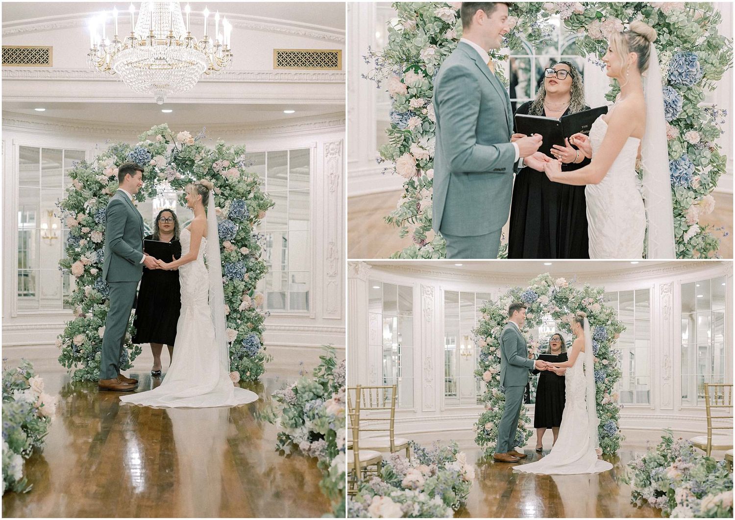 Elegant wedding ceremony under a floral arch with white and blue flowers in a grand ballroom.