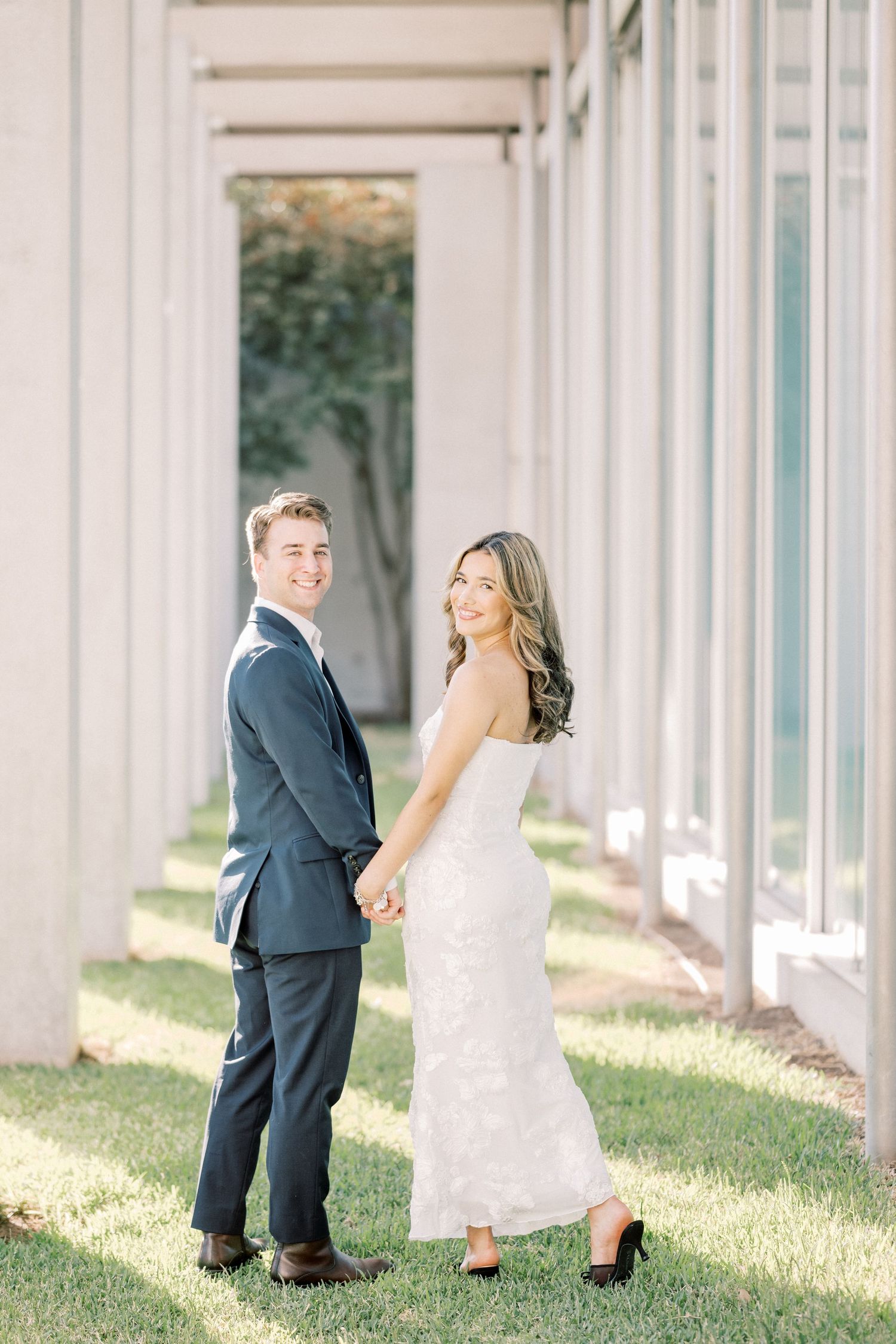 A couple in wedding attire playfully poses between white columns in a sequence of romantic outdoor photos.