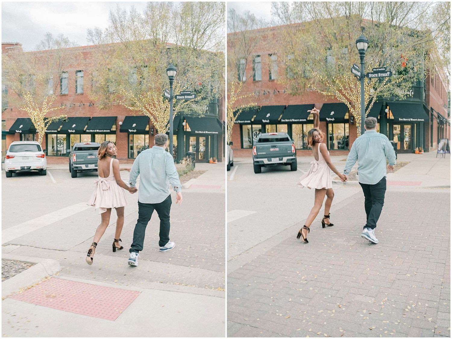 A romantic couple dancing together in front of historic brick buildings on a paved street.