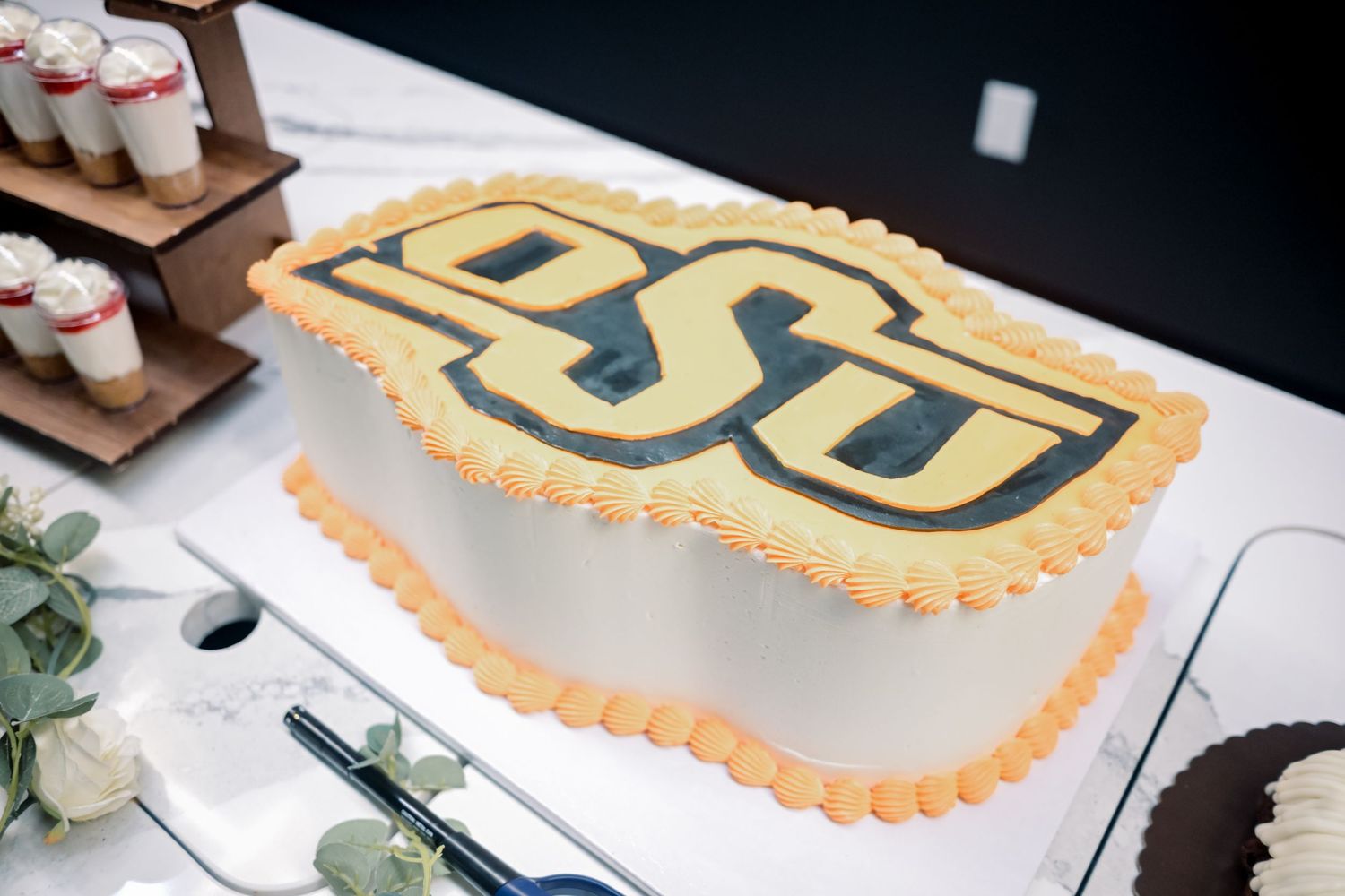 Oklahoma State University OSU themed grooms cake decorated in orange and gold school colors.