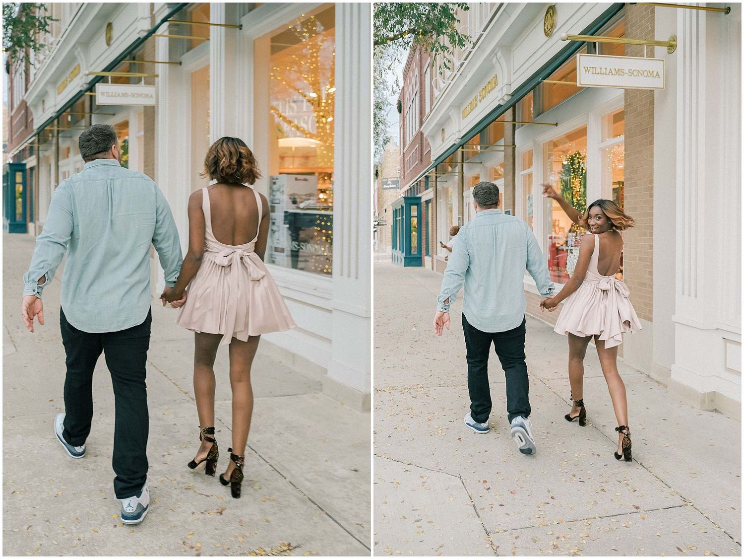 Couple walking hand in hand down urban sidewalk with storefronts visible.