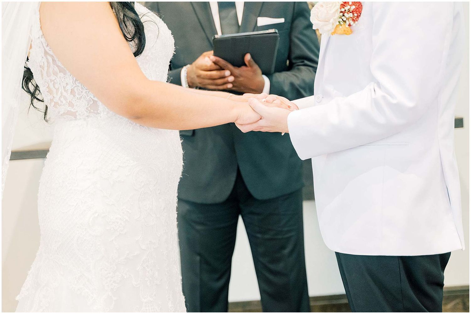 A couple exchanges rings during an intimate wedding ceremony with an officiant.