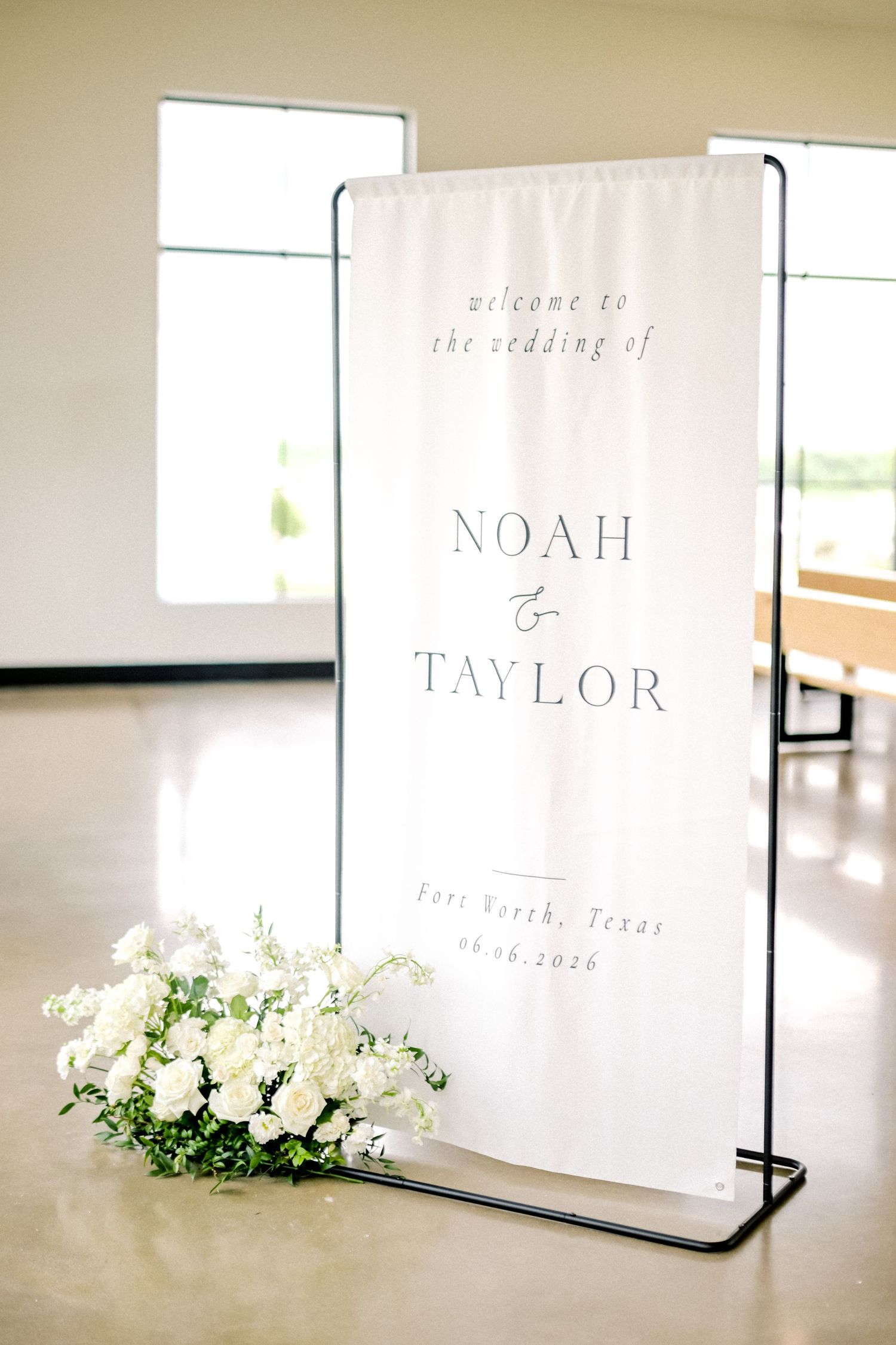 Elegant wedding welcome sign for Noah and Taylor in Fort Worth, Texas, adorned with white floral arrangements.