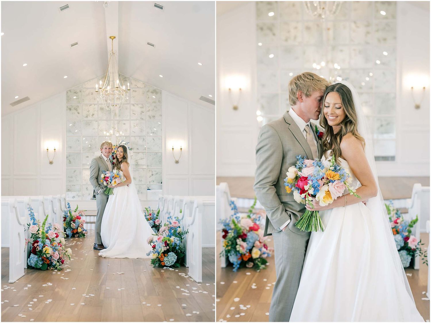 Bride and groom share a romantic kiss in an elegant white chapel adorned with colorful floral arrangements and a crystal chandelier.