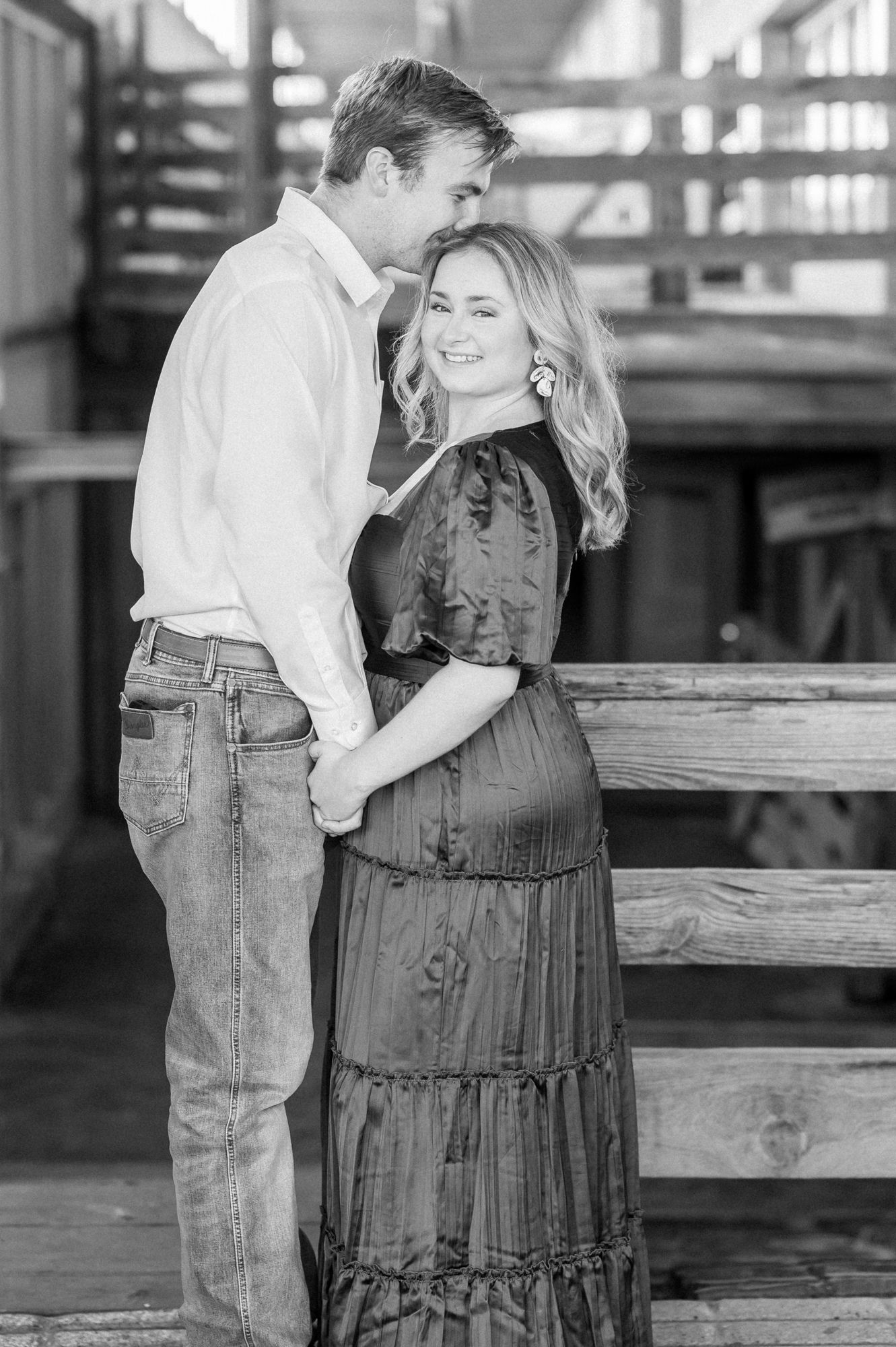 A romantic black and white photo series showing a couple in denim and casual wear standing by wooden benches.