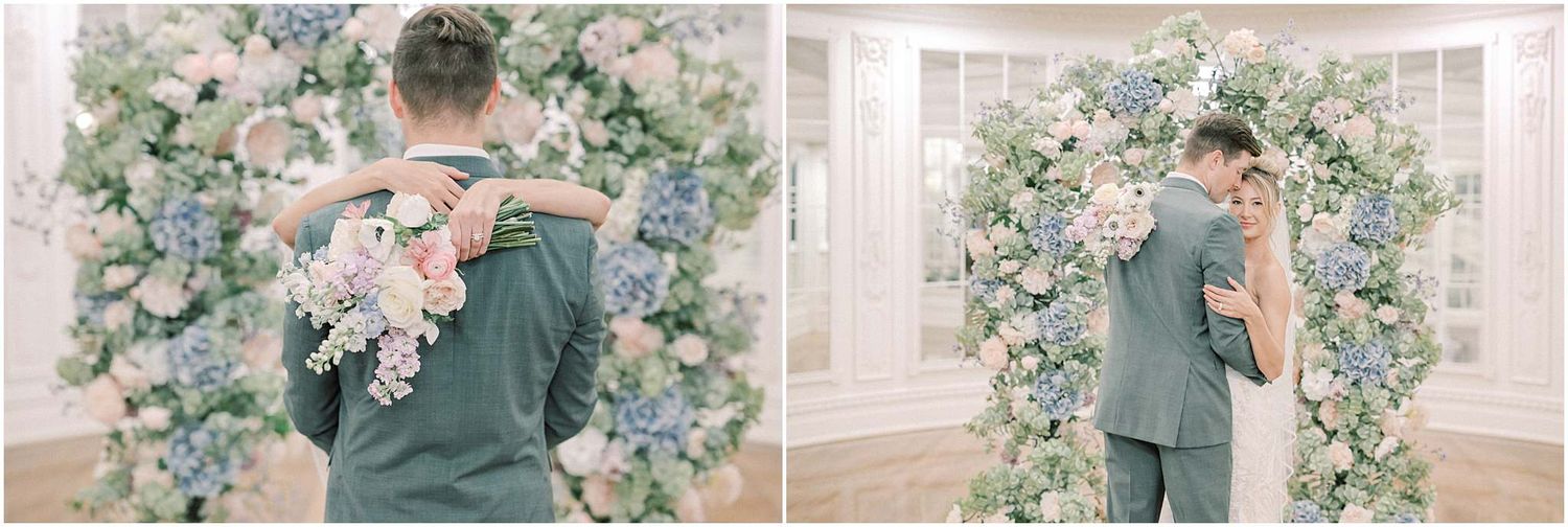Soft, pastel-toned wedding portraits captured under an elegant floral archway.