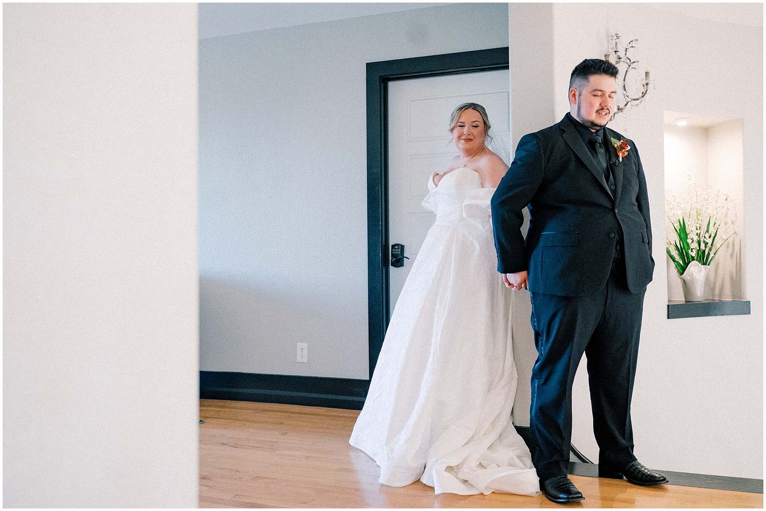 Wedding preparation moments captured in a bright interior space with white walls.