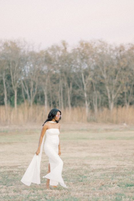 Ethereal outdoor photo shoot featuring a white dress against a natural wooded backdrop.