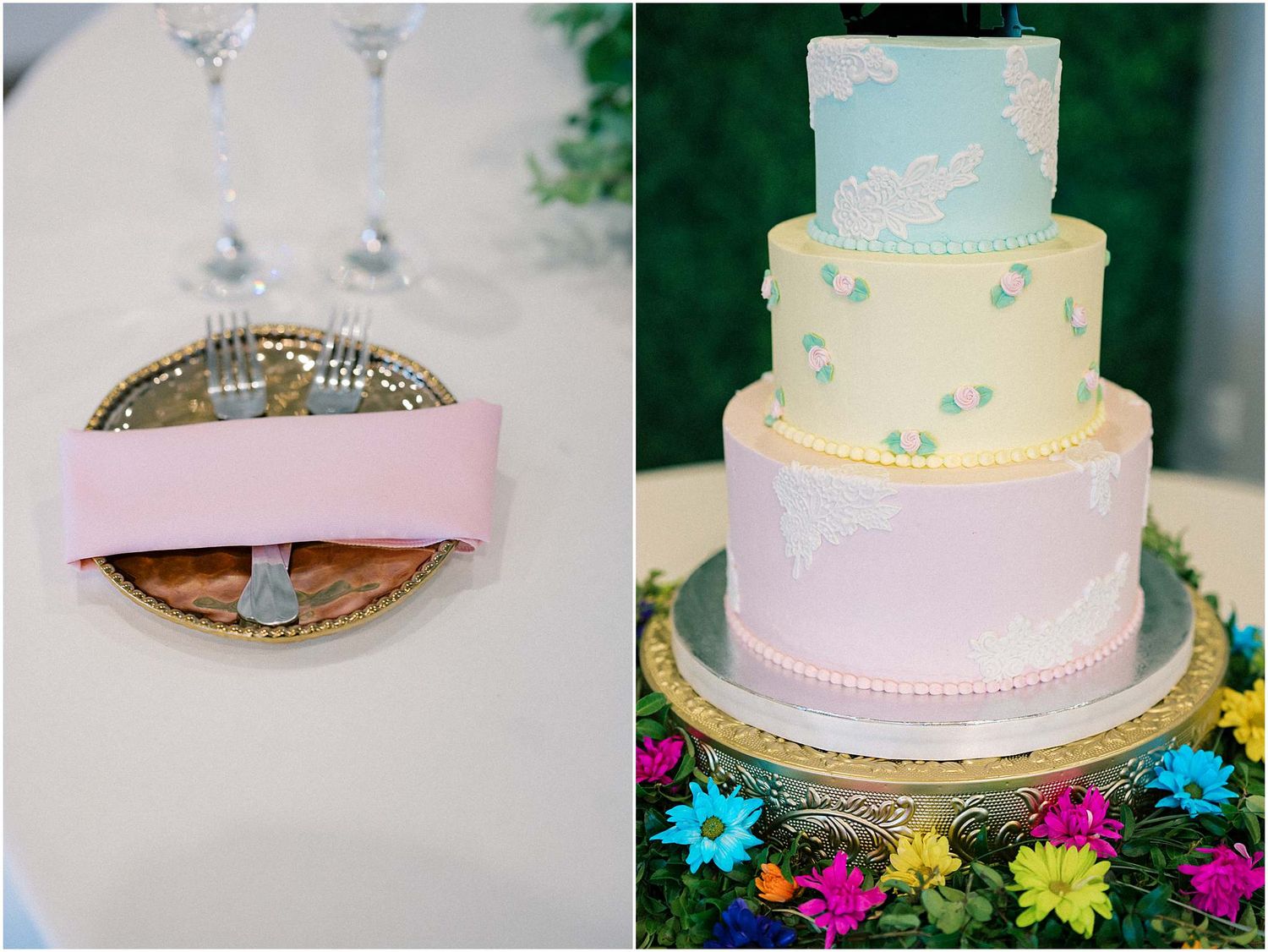 Wedding cake in pastel blue and pink with gold accents displayed among colorful flowers.