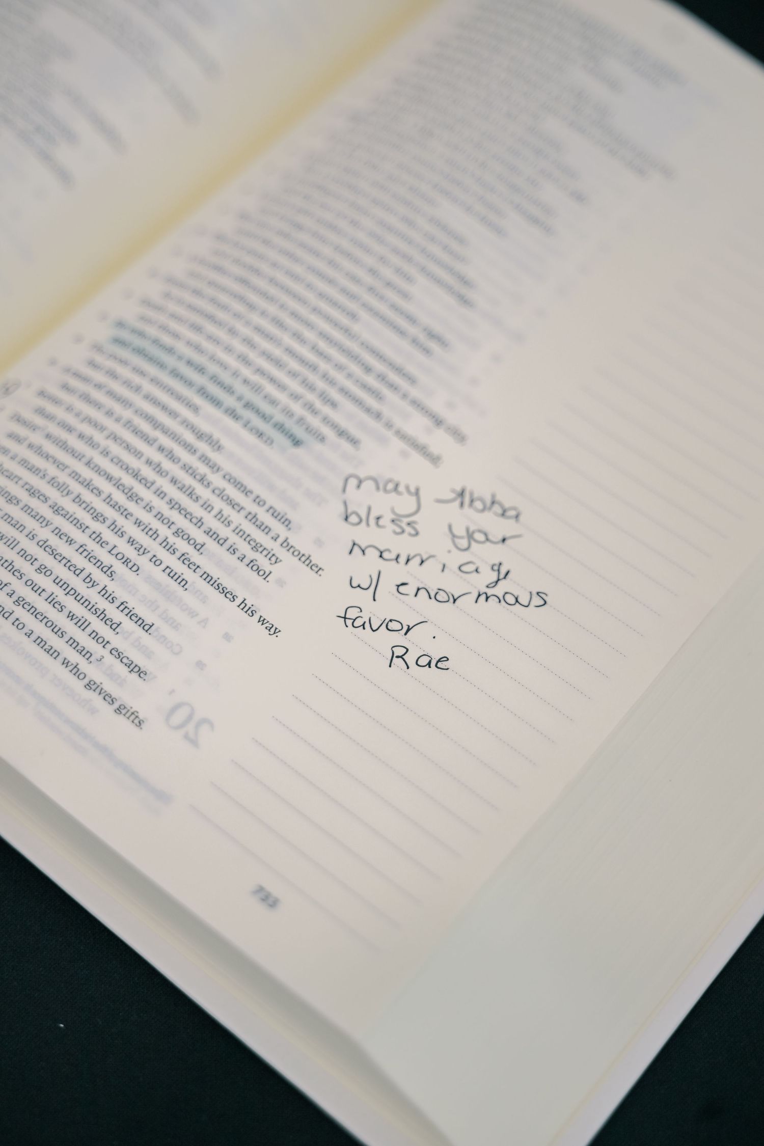 Wedding guest writes a heartfelt blessing in the margin of a Bible guestbook.