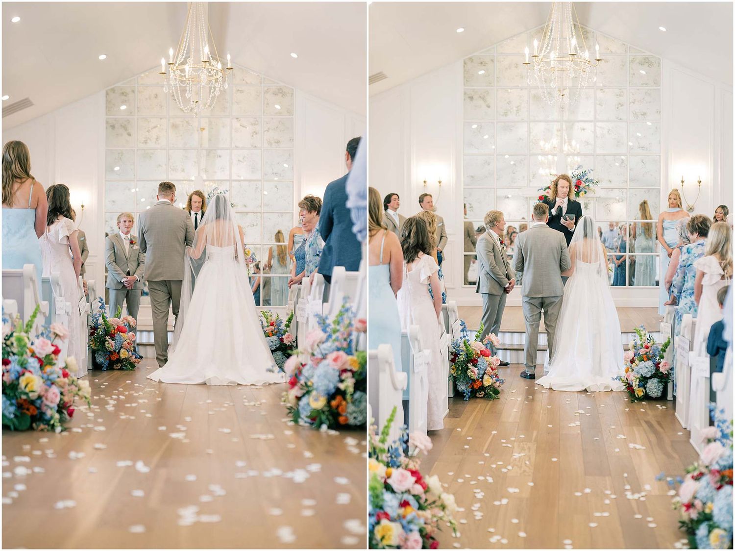 Bride and groom exchange vows at colorful floral-lined aisle in elegant white chapel with crystal chandelier.