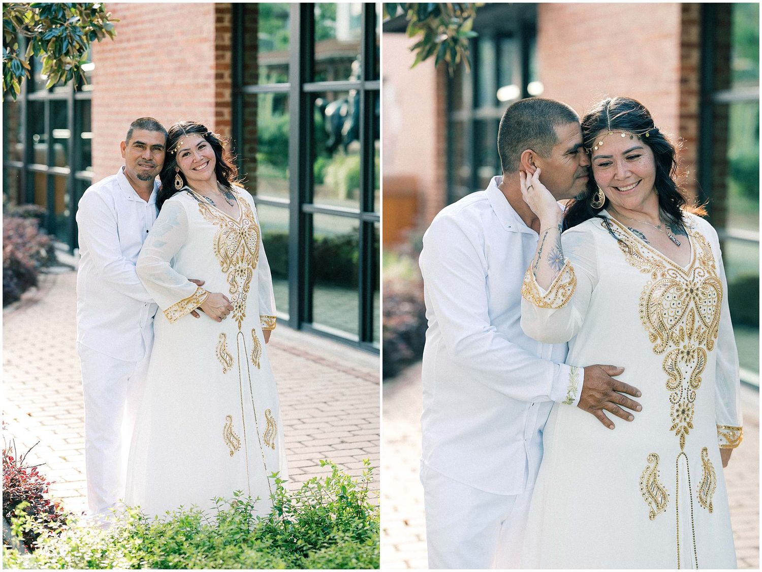 A couple in white and gold outfits poses together near a modern building.