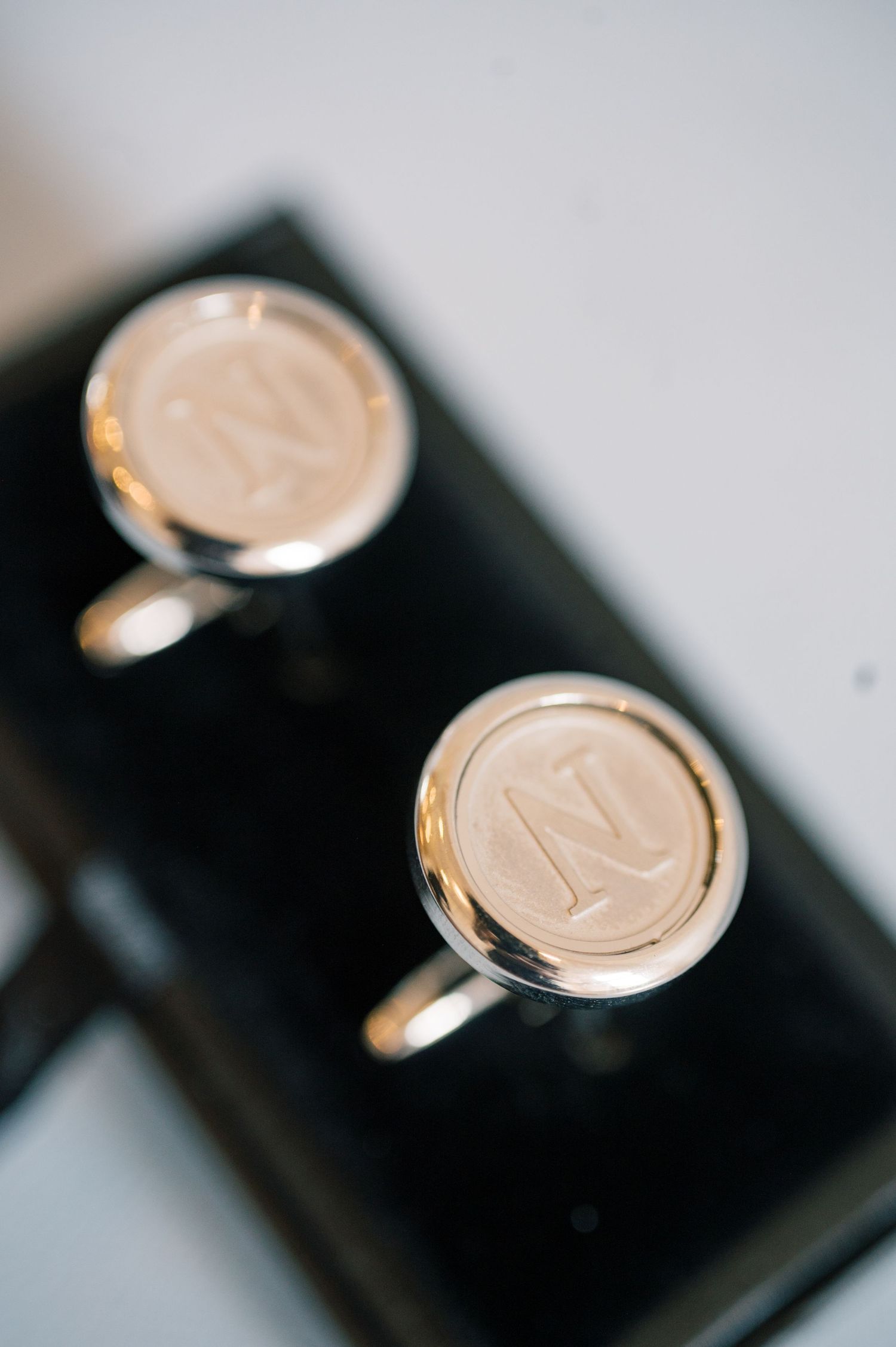 Silver monogrammed N initial cufflinks displayed in black box for wedding groom accessories.