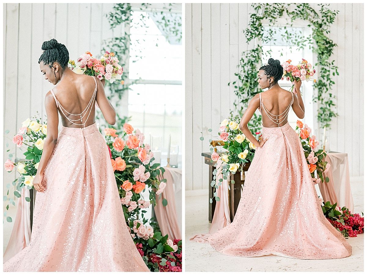 Romantic bridal portraits in pink lace gown with floral backdrop showcasing delicate back details and flowing train.