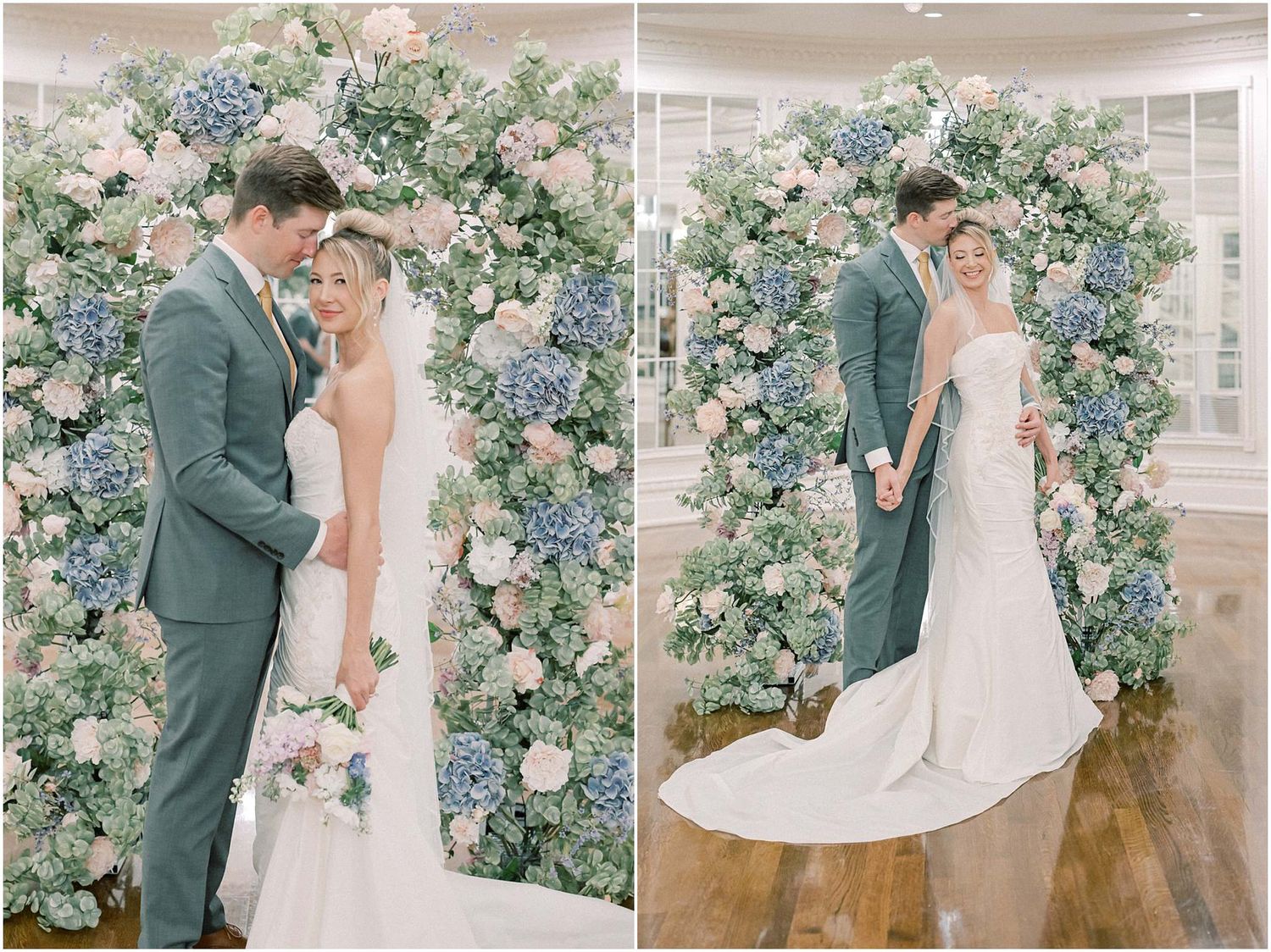 Wedding couple poses under a lush floral arch with blue and pink blooms.