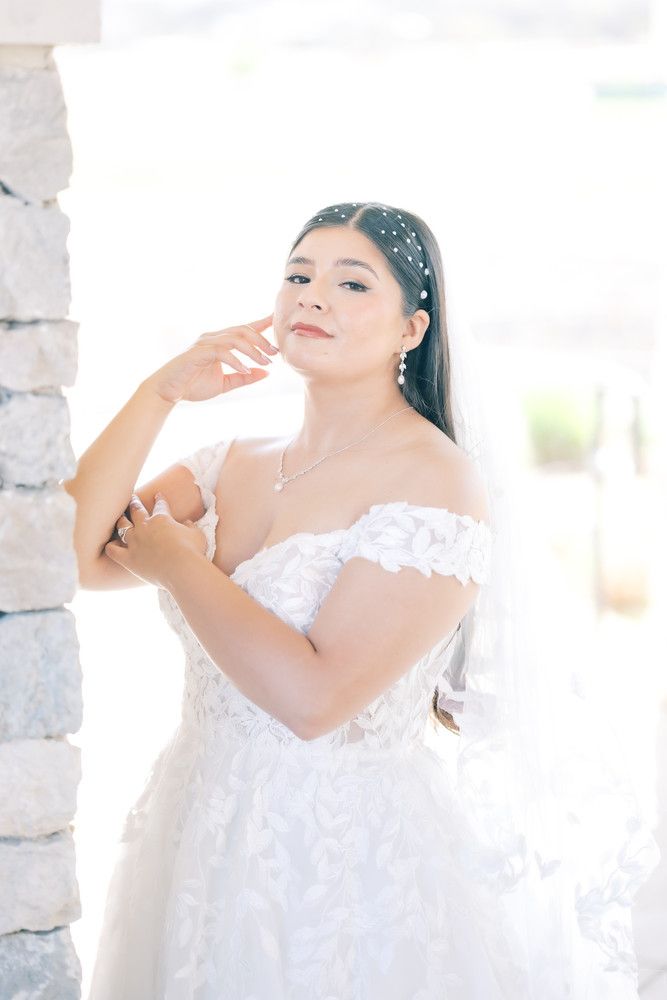 Dreamy bridal portraits captured in soft natural light against rustic stone architecture.