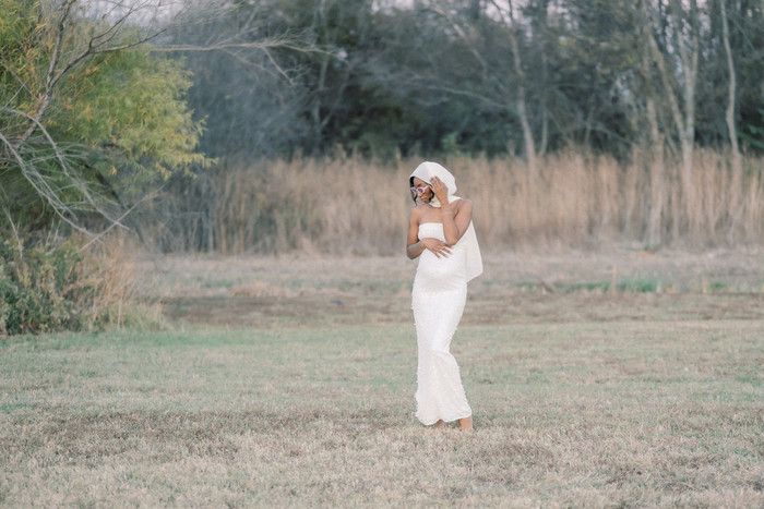 A series of artistic poses captured in a field with someone wearing flowing white fabric.