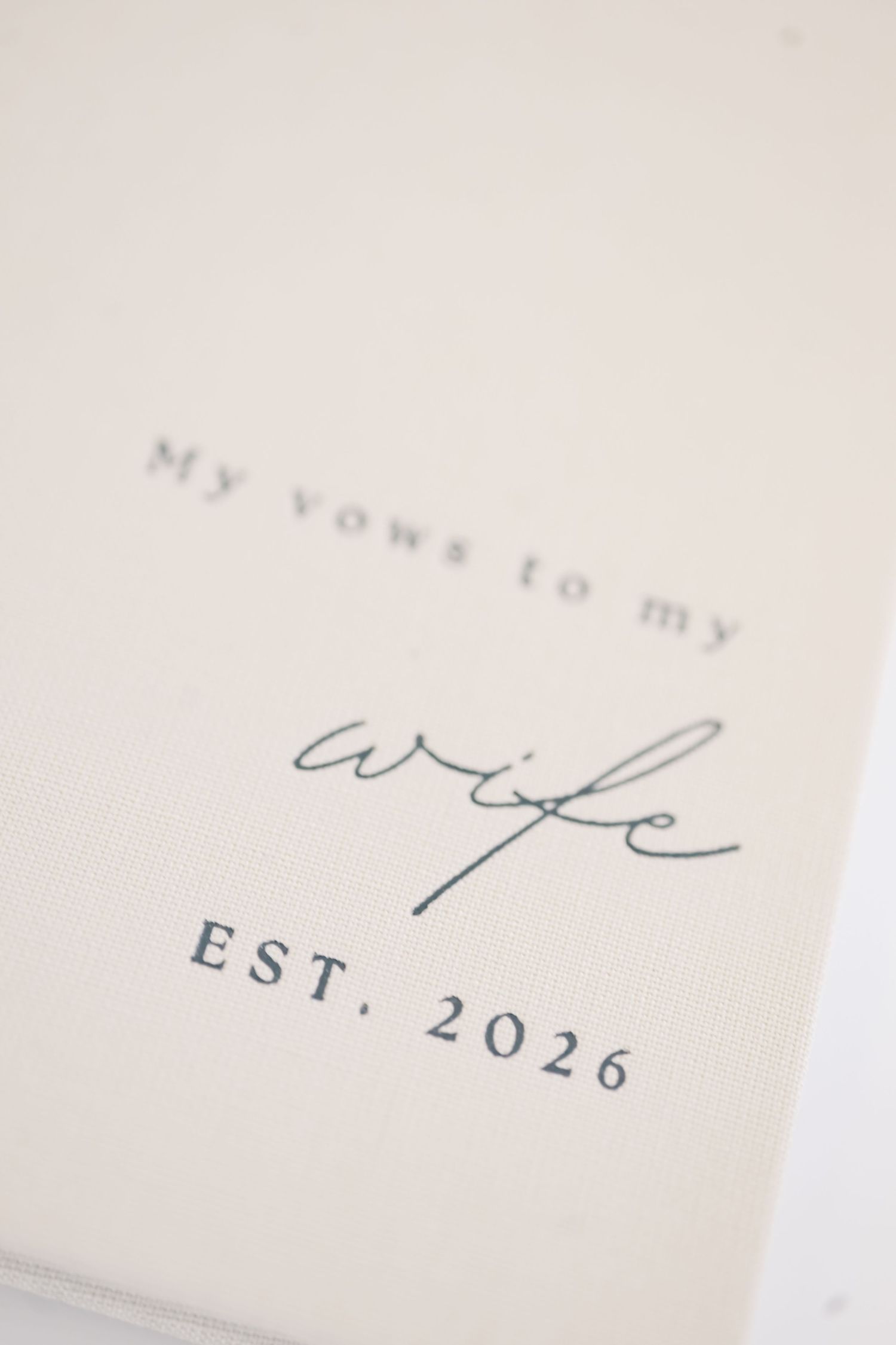 Elegant wedding vow book reading My Vows to My Wife Est. 2026 in navy script on cream linen cover.