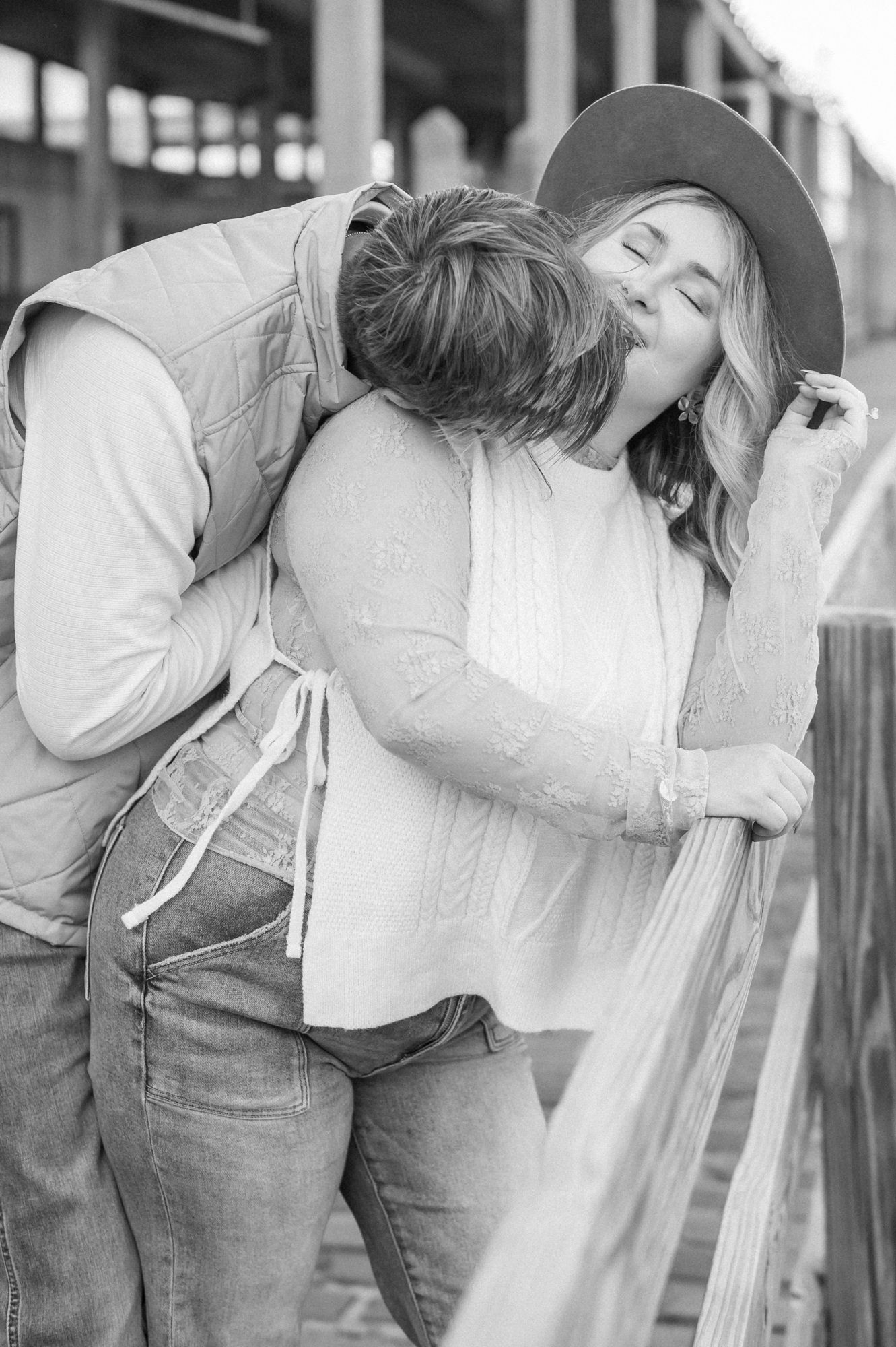 A romantic black and white photo sequence showing a couple in overalls and white shirt embracing and kissing.