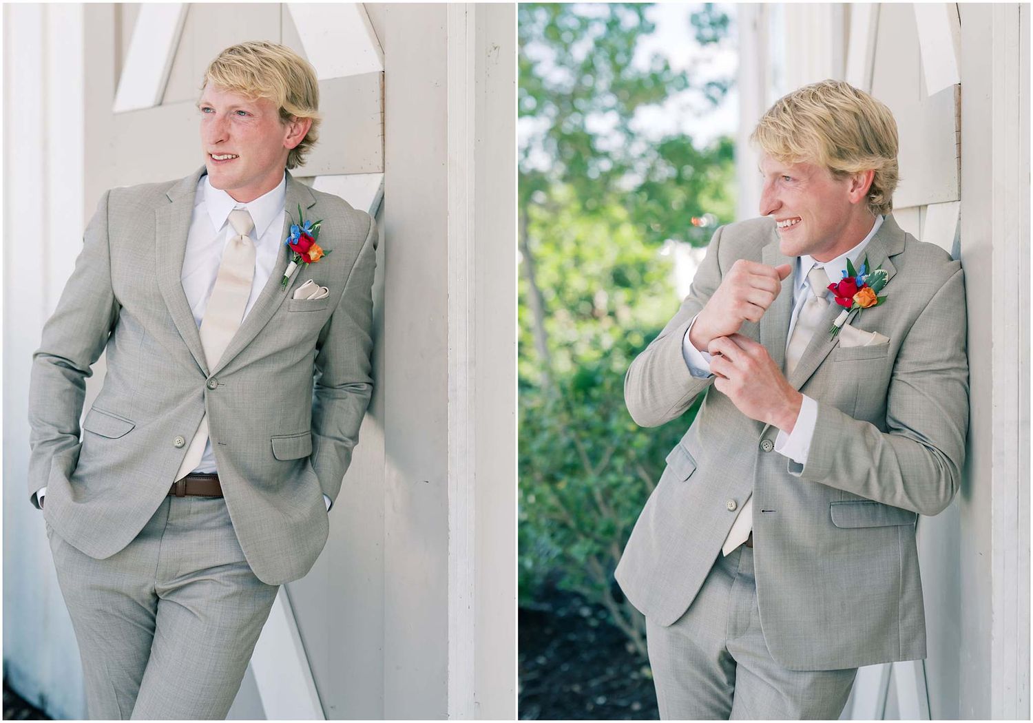 Groom in light gray suit with colorful boutonniere poses outdoors, smiling and laughing in wedding portraits.