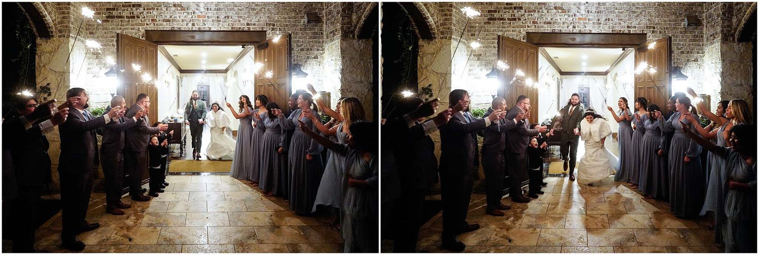 Wedding couple exits venue through sparkler send-off lined by bridesmaids in gray dresses and groomsmen.
