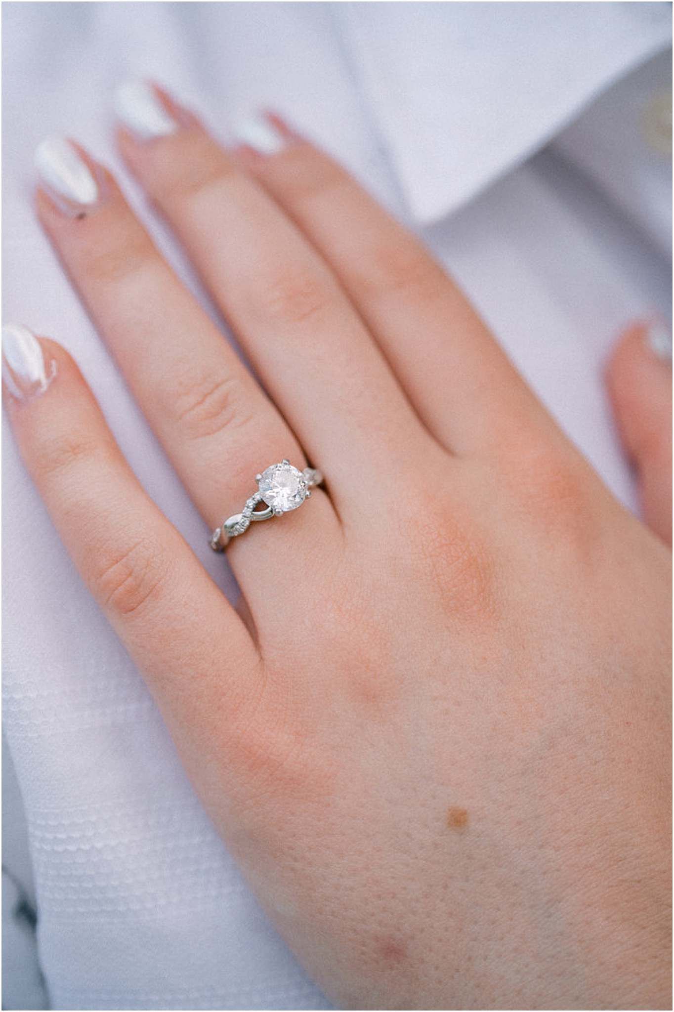 Close-up shots of an elegant diamond engagement ring on a woman's hand.