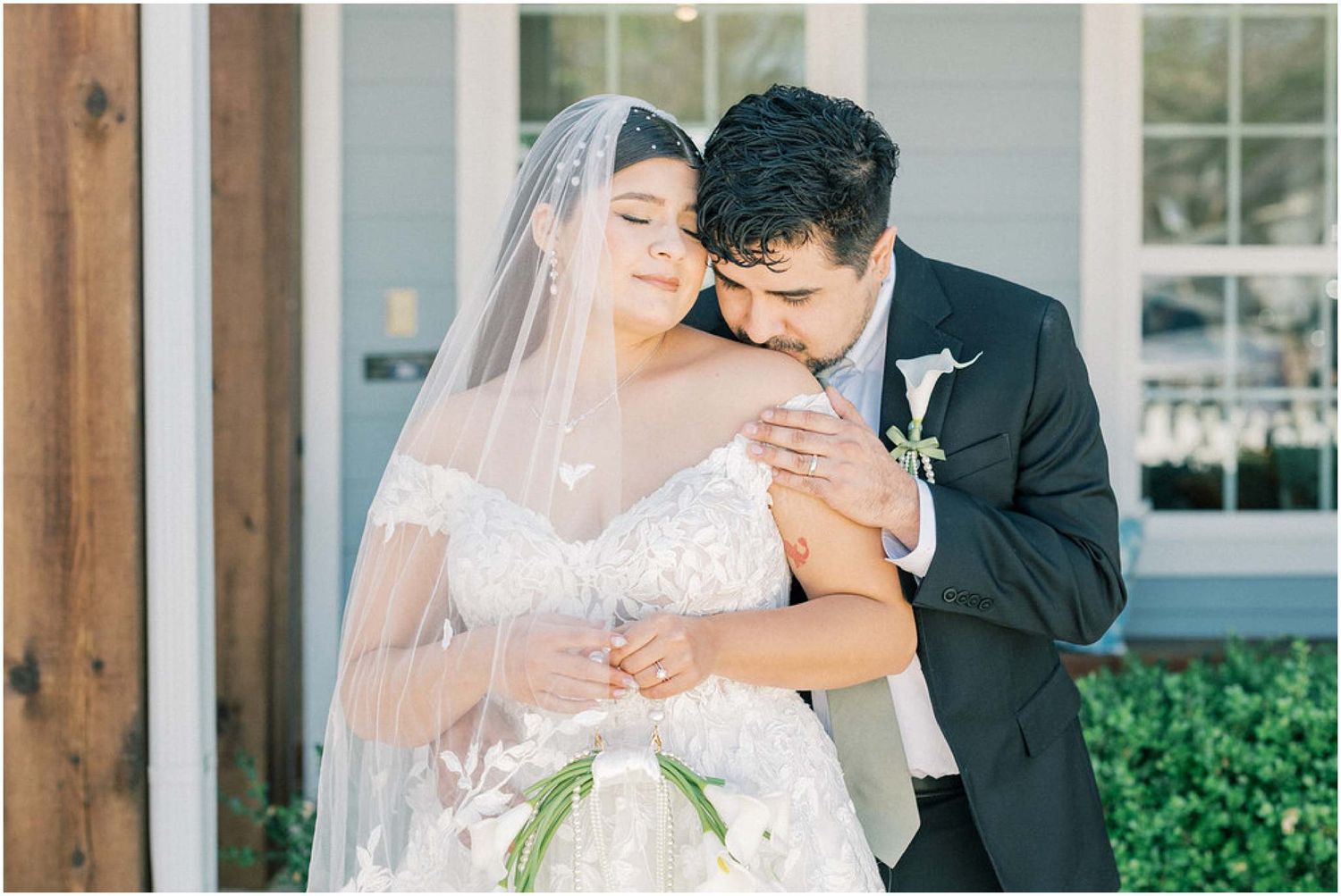 Romantic wedding couple shares intimate moments during their outdoor garden ceremony.