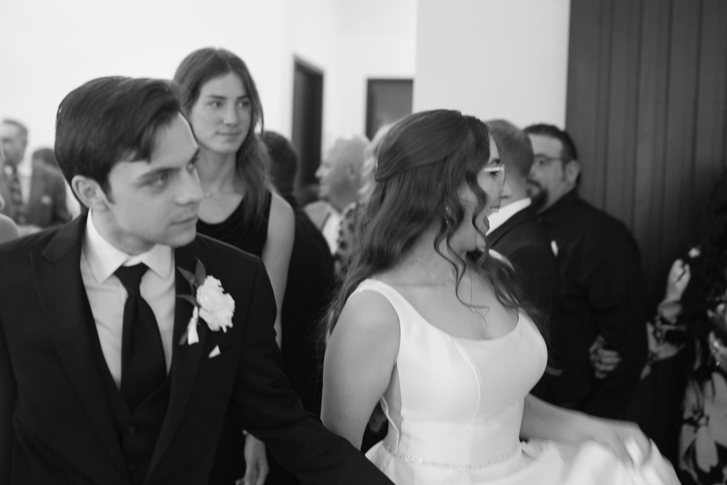 Black and white photo of bride and groom sharing an intimate moment during wedding ceremony.