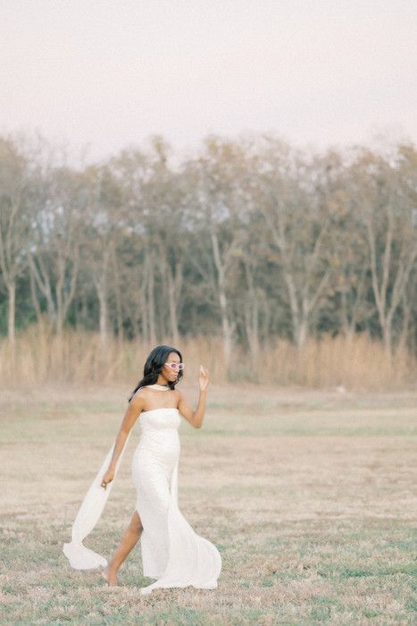 Dynamic poses captured in white flowing fabric against a natural landscape backdrop.