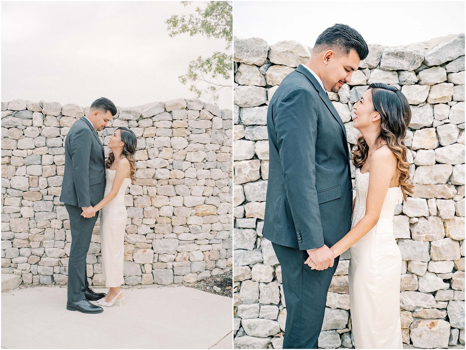 A couple shares romantic moments in front of a rustic stone wall during their outdoor wedding photo session.