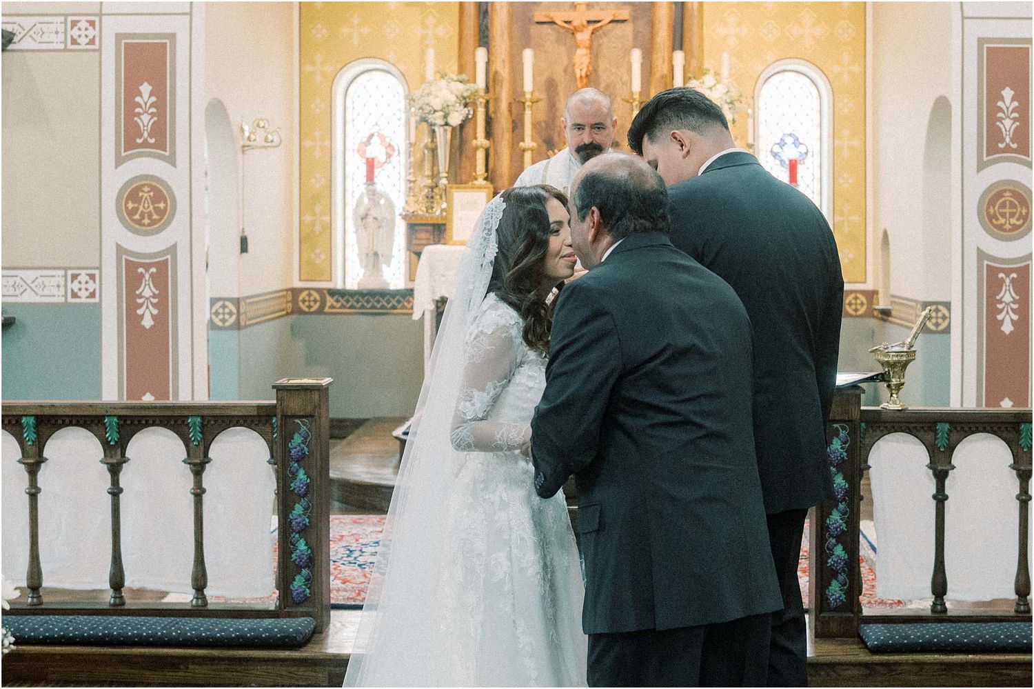 Elegant church altar decorated for a wedding ceremony with ornate gold details and white accents.