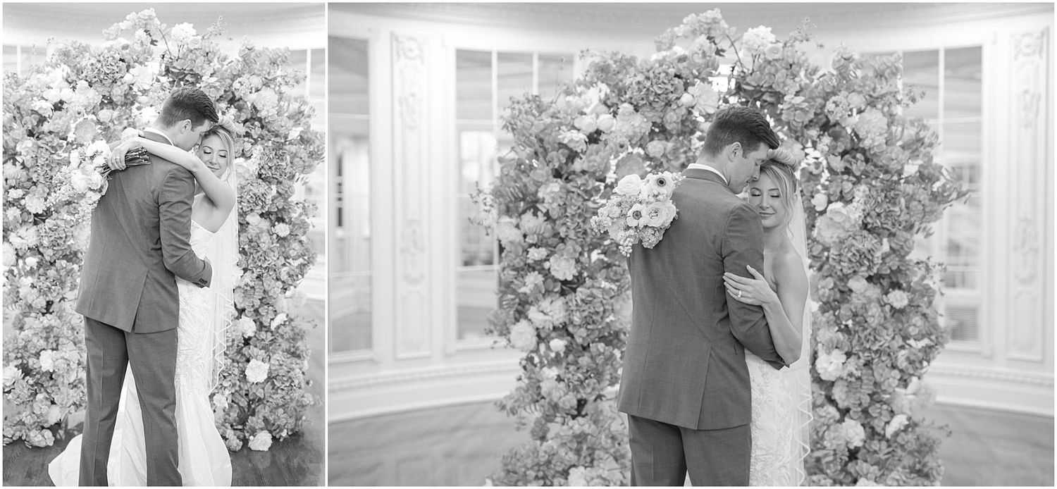 Intimate black and white wedding moments captured beneath a flower-adorned arch.