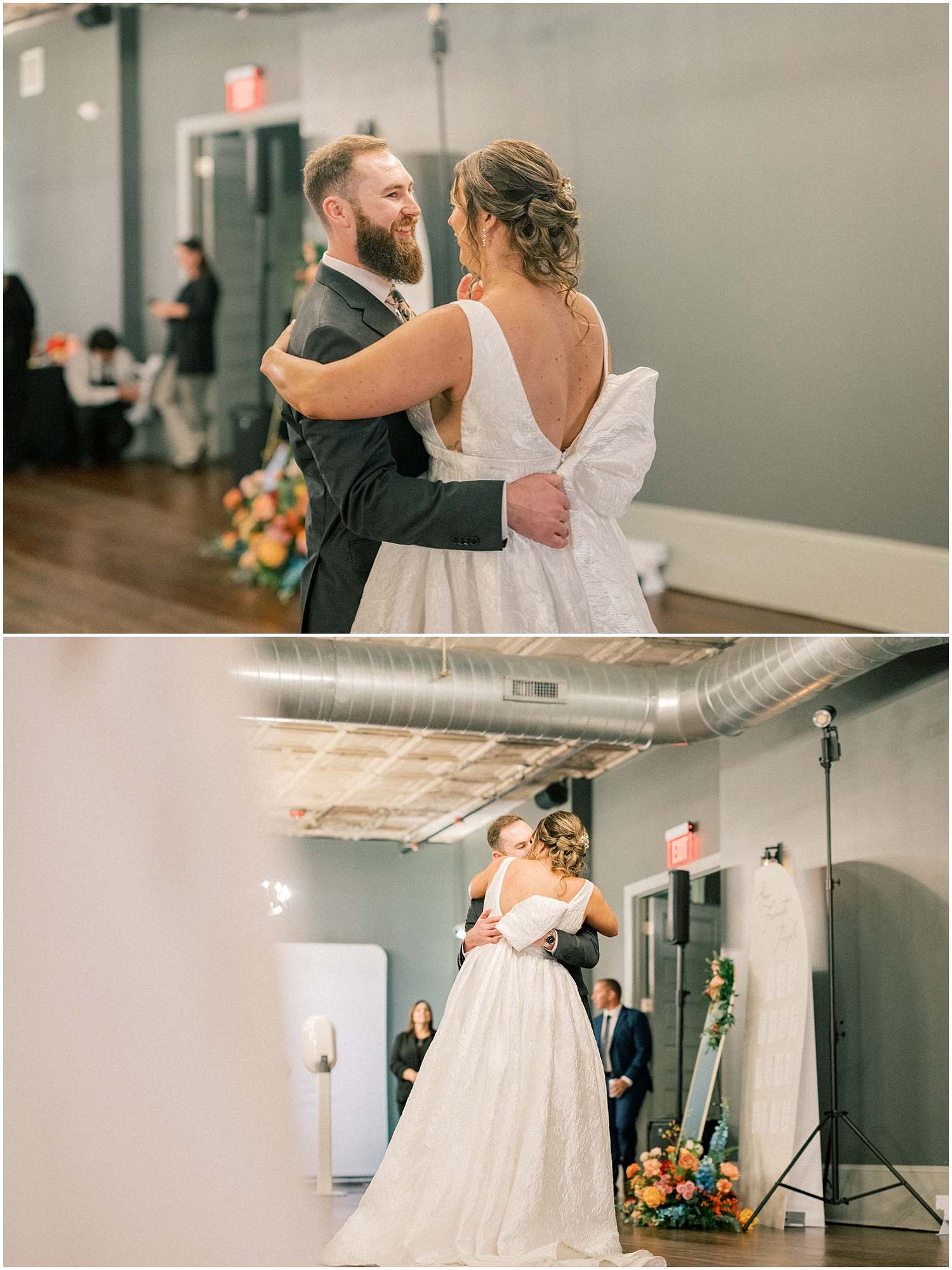 Wedding couple sharing their first dance in an elegant modern venue with floral arrangements.