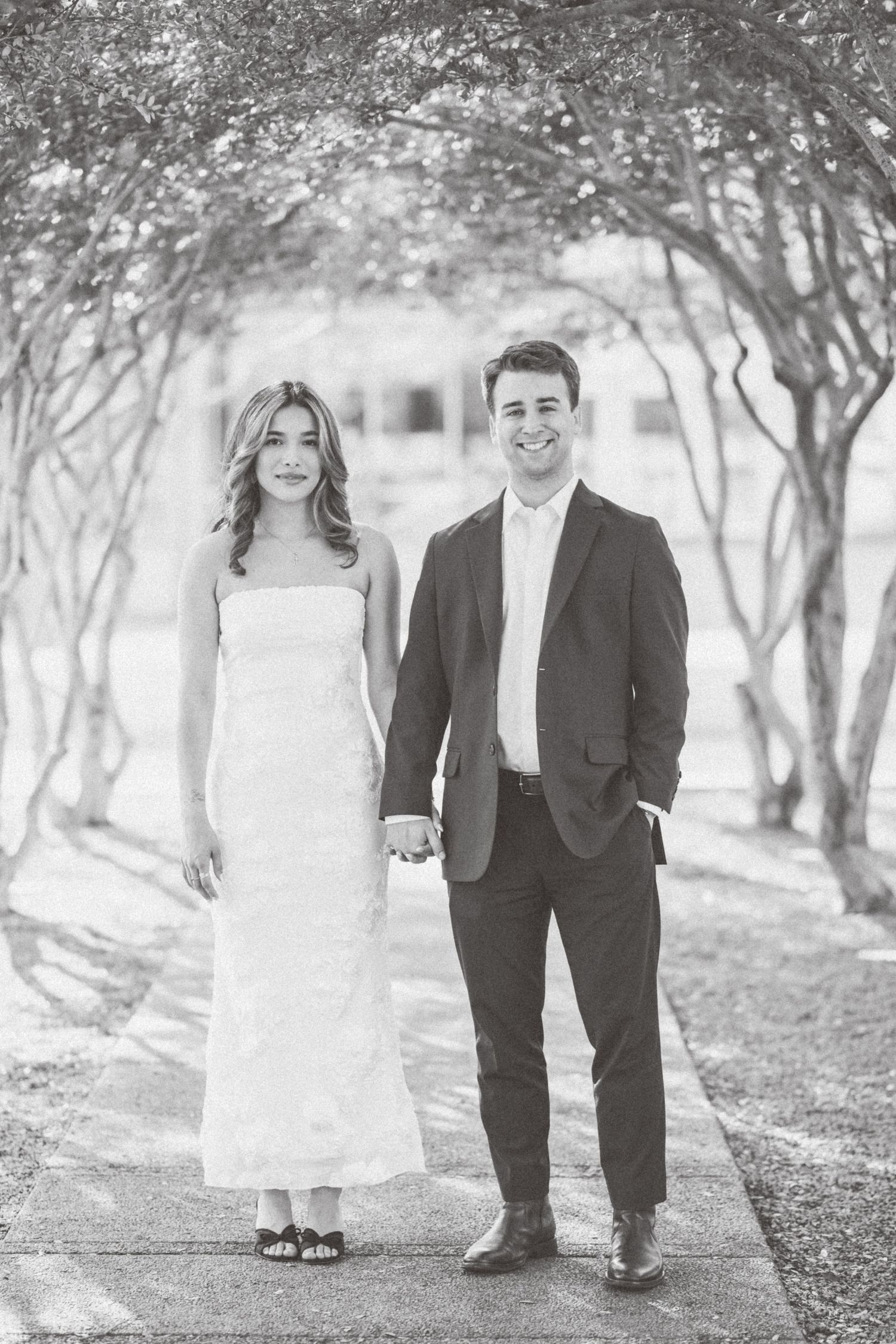 A series of black and white wedding photos showing a couple walking together in a tree-lined path.
