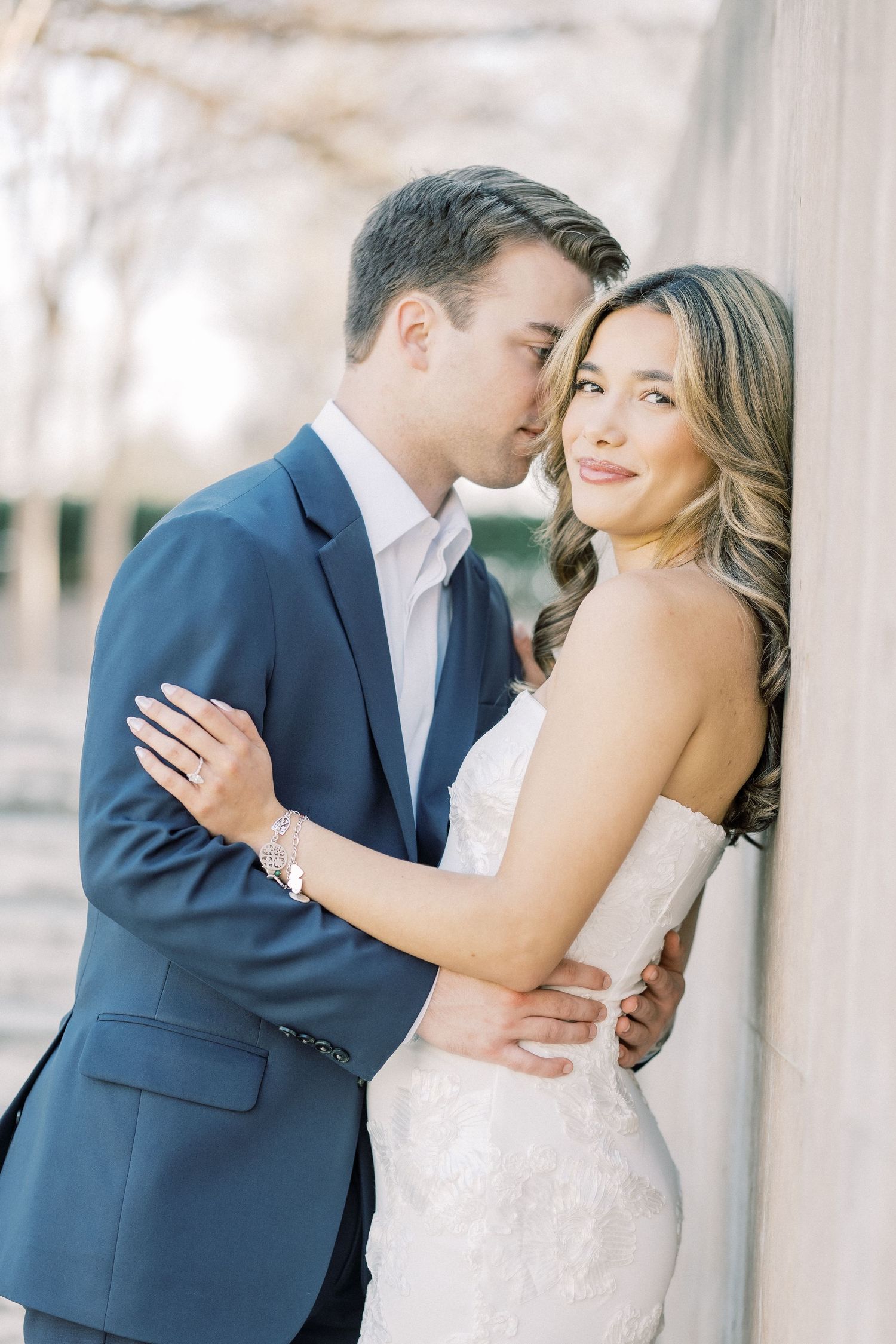 A romantic wedding couple shares intimate moments in a series of elegant outdoor portraits.