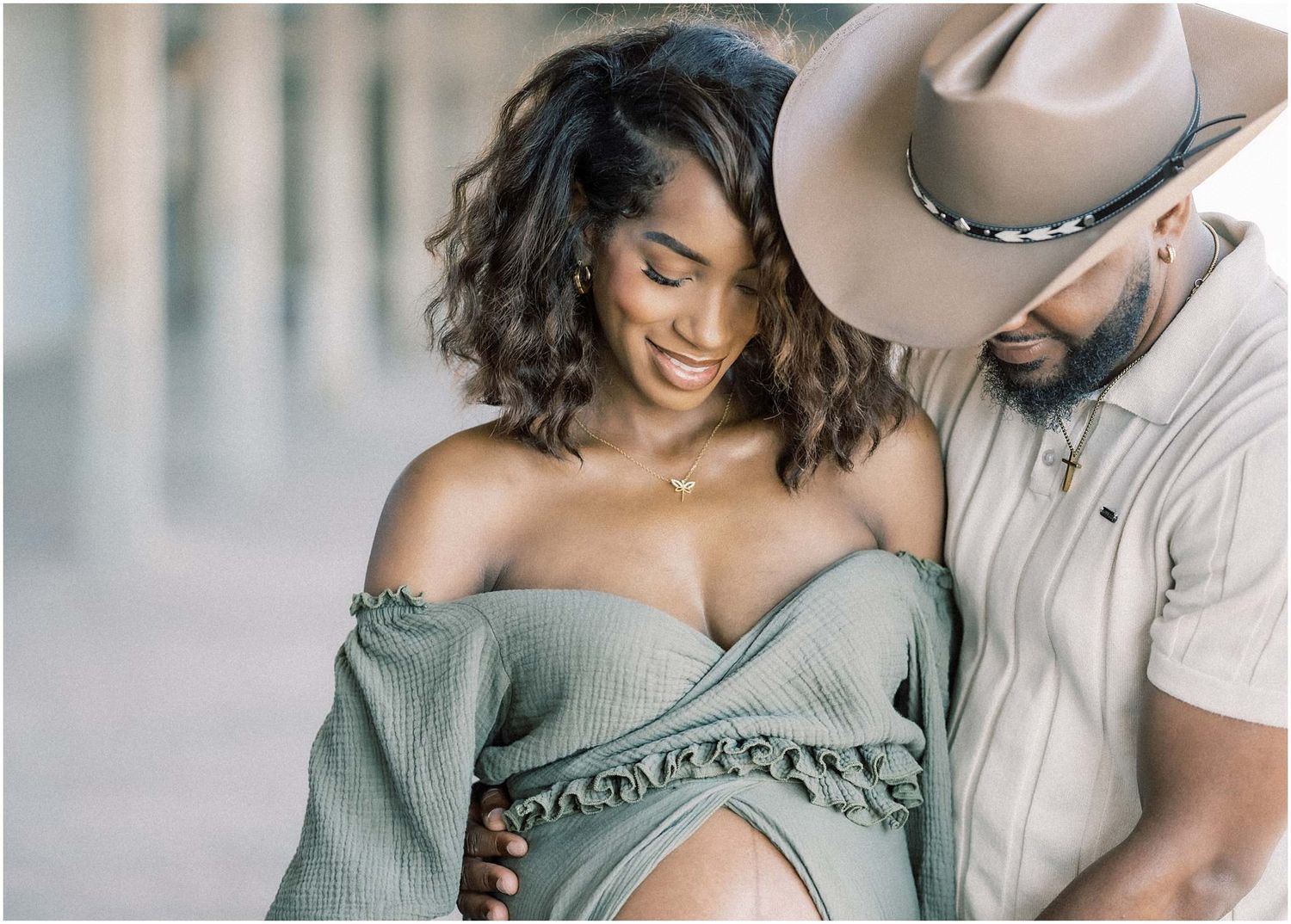 Intimate maternity portraits featuring a sage green off-shoulder dress.