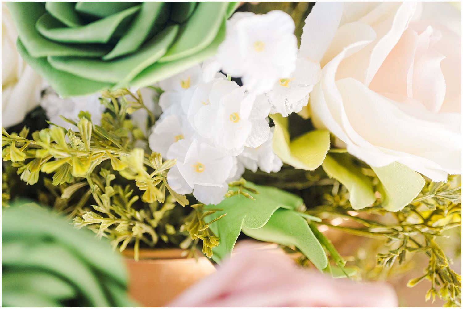 Close-up details of pale pink and green floral arrangements with roses and greenery.
