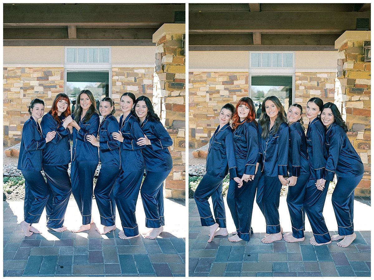 Bridesmaids in matching navy robes pose together on stone patio.