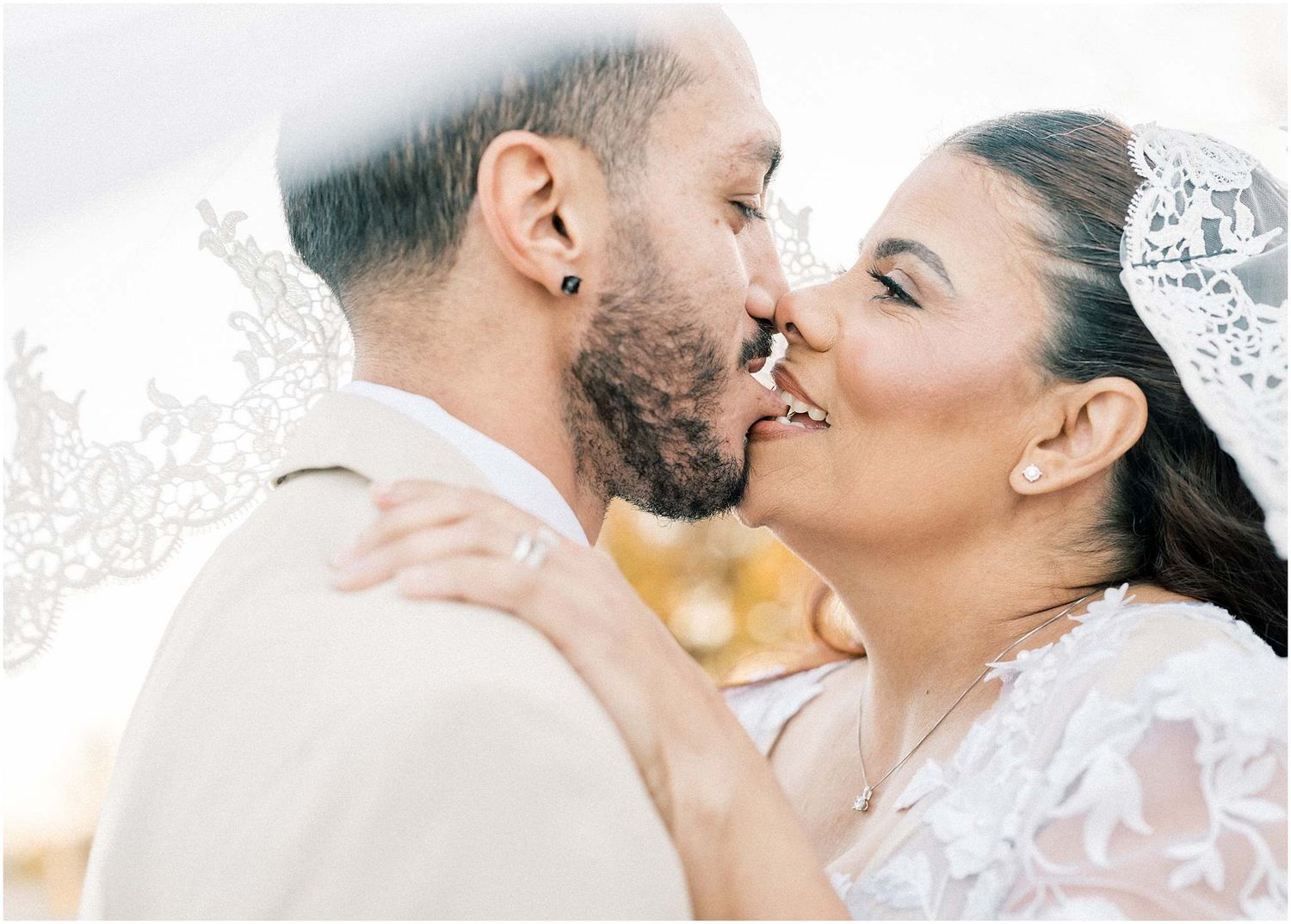Close-up romantic wedding portraits showing tender moments between newlyweds in soft lighting.