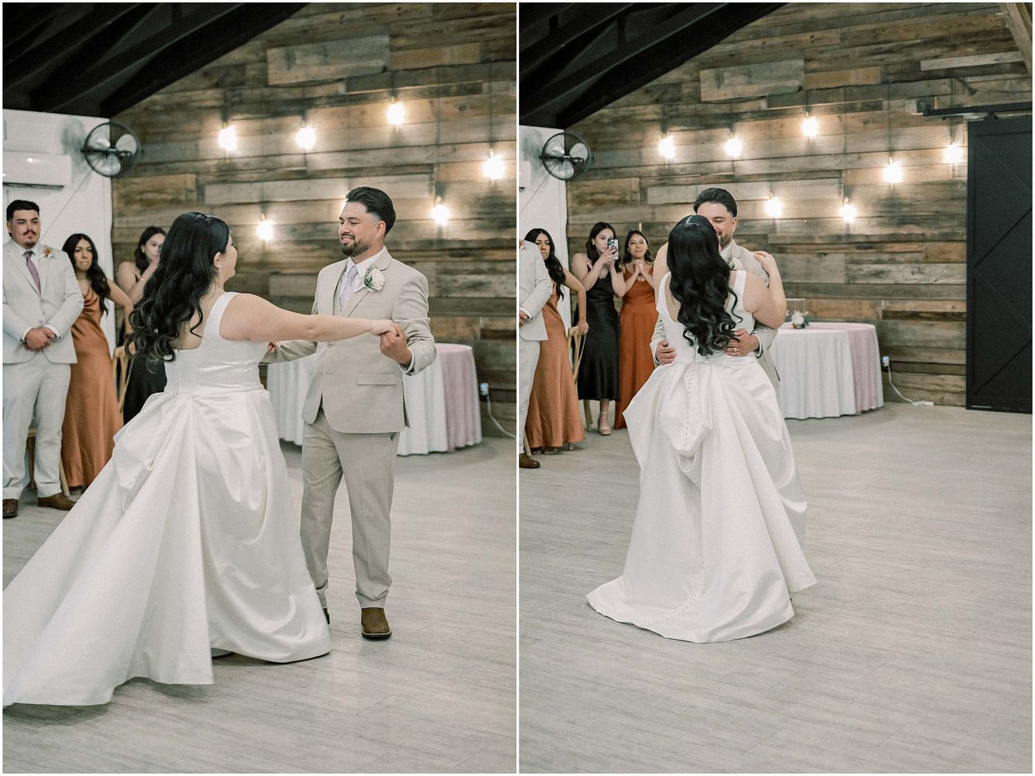 Couple sharing a romantic dance moment on their wedding day in a rustic venue with string lights.